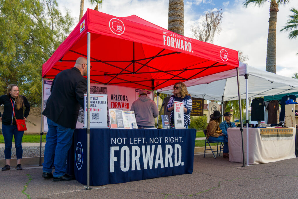 Signature gatherers collect signatures at a Forward Party table in Arizona.